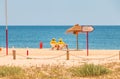 Lifeguard dressed in yellow sitting on a chair on the beach Royalty Free Stock Photo