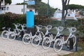 Vilamoura, Portugal - a row of parked rental bicycles in the streets