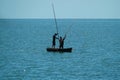 VILLA CLARA, CUBA - Apr 25, 2018: Two Men Sailing on a Fishing Boat in a Clear Day