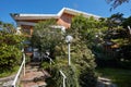 Villa with garden and stone staircase in a sunny summer day, clear blue sky Royalty Free Stock Photo