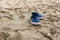 Blue flip flops on the sand of a beach in summer