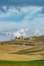 Villa in Italy, old farmhouse in the waves of tuscanian fields and hills Royalty Free Stock Photo