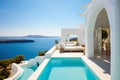 Villa with luxury pool overlooking sea at sunset. Resort hotel on mountain top, scenery of white house and terrace in Greek style Royalty Free Stock Photo