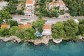 Villa with a pool among green trees on a rocky seashore. Croatia. Drone