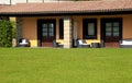 Villa with terrace and green grass in village resort, Italy Royalty Free Stock Photo