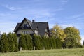 Villa is among the trees. Typical European building. Territory of Poland. Beautiful autumn day. e