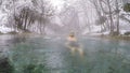 Villach - A man swimming in a natural hot spring in winter Royalty Free Stock Photo