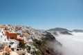 Village above clouds. View of Oia village, Santorini caldera, Greece. Royalty Free Stock Photo