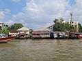 A village along the Chao Phraya River in Bangkok, with a boat. Royalty Free Stock Photo