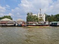 A village along the Chao Phraya River in Bangkok, with a boat. Royalty Free Stock Photo