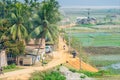 Village in Assam India near rice fields