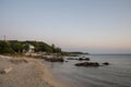 Small peaceful beach at sunset, beautiful seascape, boats in the background, travel destination, summer vacation