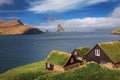 Village of Bour on Faroe Islands with Drangarnir sea stack in the background