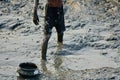 Village boy is fishing in a muddy pond stock photo