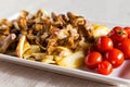 Village breakfast - fried potatoes and mushrooms with tomatoes on white plate Royalty Free Stock Photo