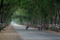Village Children enjoying bike ride on an empty countryside road in India