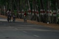 Village Children enjoying bike ride on an empty countryside road in India