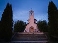 Village church against overcast sky after sunset Royalty Free Stock Photo