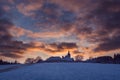 Village with a church on a hill at sunset in winter, beautiful sky, Vezovata Plane, Czech republic Royalty Free Stock Photo