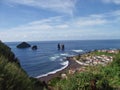 The village Feteiras and bizarre rock formations in the sea. Sao Miguel, Azores. Royalty Free Stock Photo
