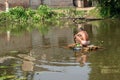 A village fisherman is throwing a net for fishing in a pond Royalty Free Stock Photo