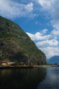 Village in Flam, Norway. Country houses at sea shore on mountain landscape. Fjord and mountains on cloudy sky. Vacation Royalty Free Stock Photo