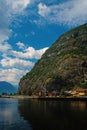 Village in Flam, Norway. Country houses at sea shore on mountain landscape. Fjord and mountains on cloudy sky. Vacation Royalty Free Stock Photo