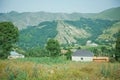 Green forest, green grass . Green colorful landscape . small village located at the foot of the mountains . houses built at the Royalty Free Stock Photo