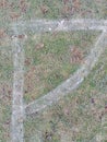 Football pitch corner marking on grass covered by hoar frost.