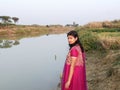 A village girl stood at the bank of the river, spring time