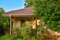 Village house in Serbia. Green grass, trees and flowers all around Royalty Free Stock Photo