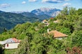 Village Houses Amongst Dense Trees With View to Mountain Ranges, Greece Royalty Free Stock Photo