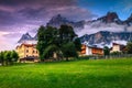 Village with houses and high mountains at sunset, Dolomites, Italy Royalty Free Stock Photo