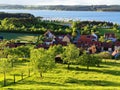 Lakeside village idyll in spring by lush green nature