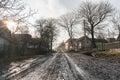 Village landscape, swamp and wet road, old houses and trees around, countryside path, road theme, Western Ukraine Royalty Free Stock Photo