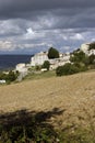 Village in the Luberon France. Moody sky, ploughed field.