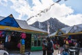 Village market with people, Tibetan prayer flags and mountain with snow in the background in winter at Gangtok, Sikkim. India Royalty Free Stock Photo