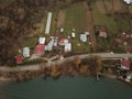 Village near the lake seen from the drone in early spring. aerial capture on a foggy day