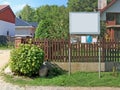 Village news and announcement board set near a wooden fence