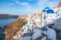 Village of Oia with white cave houses and churches with blue domes overlooking the beautiful sea Royalty Free Stock Photo