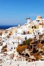 Village of Oia with Windmill. Santorini, Greece. Royalty Free Stock Photo