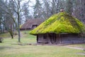 Village. Old wooden log house. View with window, front door and with moss on the roof. Royalty Free Stock Photo