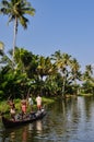 Village people carrying rocks in a boat, Kerala India.