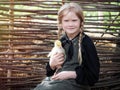 Village red-haired girl with goose chick