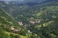 Village with red roofed houses in the wooded mountains in Kosovo