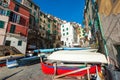 Village of Riomaggiore town with color houses and moored boats. Riomaggiore is a popular town in Cinque Terre national park in Ita