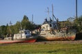 A village in Russia in the summer, children play on old rusty ships. The village of Ust-Tsilma, the original authentic life of the