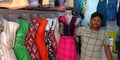 village shopkeeper selling girls dress at street shop in india