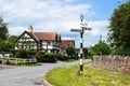 Village signpost and buildings, Weobley. Royalty Free Stock Photo