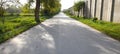 village small road with sun rays in a beautiful summer day. Royalty Free Stock Photo